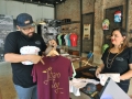 Emilio Meléndez y Vanessa Cardez muestran camisas que tienen en venta